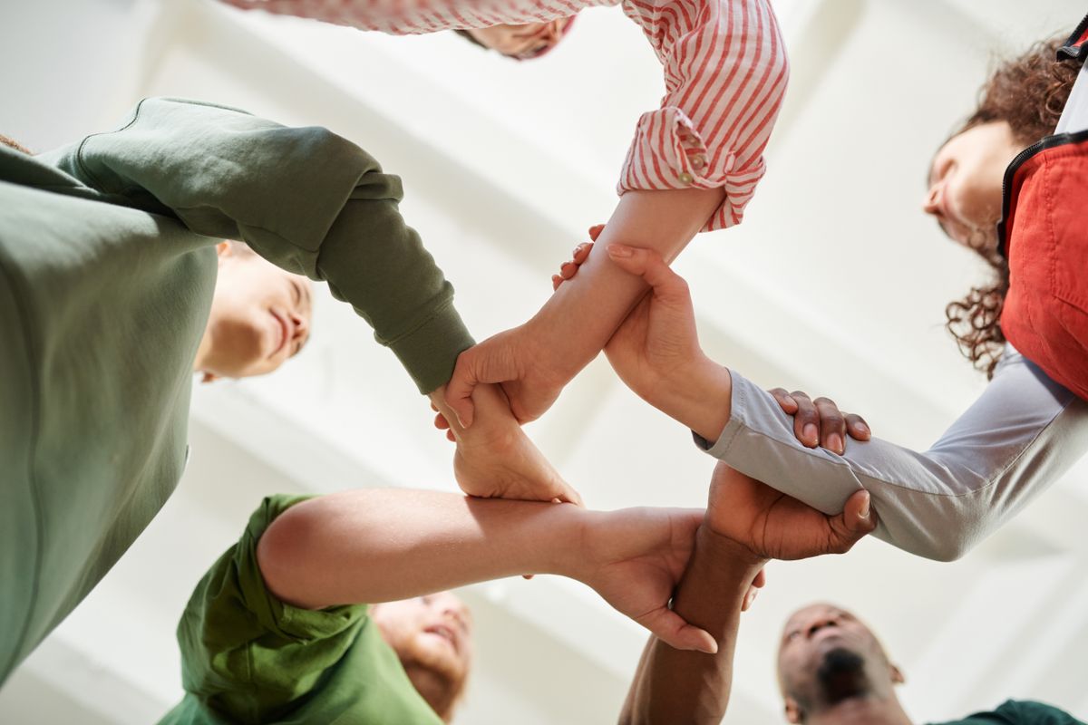 Group joining hands together